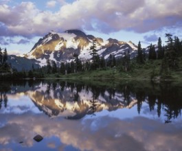 Twilight descends on Mount Shuksan in the North Cascades National Park as its snowy peak reflects