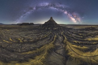 Stunning night scape of Utah sandstone desert under the Milky Way. The starry sky arches over