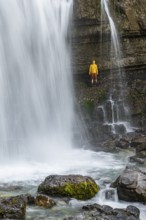 Adventure, Little hiker under large Cascata di Mezzo waterfall, long exposure, Vallesinella,