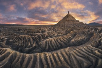 Stunning landscape of Factory Butte in Utah bathed in the warm glow of sunset with dramatic sky and
