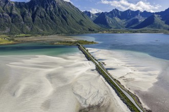 Aerial view of a bridge over turquoise sea at a sandy beach, fjord Grunnforfjorden, Lofoten