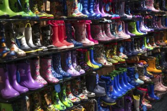 Colourful rubber boots in a shoe store, Bavaria, Germany