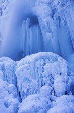 Urach waterfall full of bizarre ice formations frozen at winter temperatures, Bad Urach, Swabian