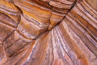 Close-up image of layered red rock formations showing vivid stripes and textures. Perfect for