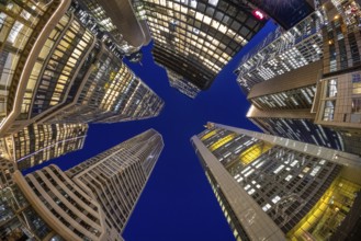The glowing skyscrapers of Frankfurt's banking skyline rise into the blue evening sky, Frankfurt am