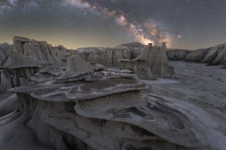 A captivating night view of unique rock formations under a vibrant Milky Way in Utah, USA,