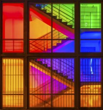 View through the windows of a brightly lit staircase. Frankfurter Mainova AG building, city center,