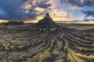 Dramatic sunset casts vibrant colors over the unique, eroded landscape of Factory Butte, Utah,