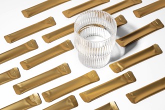 From above a golden jelly collagen sachets arranged on a white background alongside a transparent