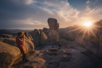 A photographer captures the stunning sunset over Pedriza's iconic rock formations in the Sierra de
