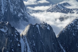 Snow and ice, epic mountains with steep cliffs, aerial view, Alaska Range, Denali National Park,