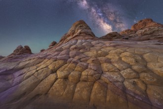A breathtaking view of the Milky Way illuminating a unique, textured rock formation in Coyote