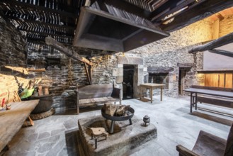 Traditional Lugo, Spain country house featuring rustic stone walls and a large open hearth in a