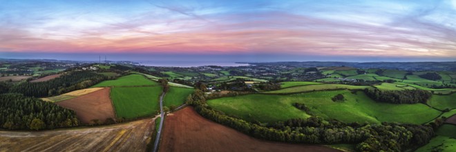 Sunset of Devon Farms and Fields over Berry Pomeroy from a drone, Totnes, England, United Kingdom