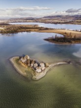 Aerial view, top-down view of an island in a shallow water zone in Lake Constance, behind it the