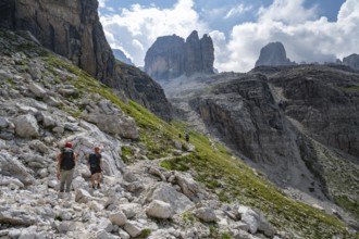 Two mountaineers in front of picturesque mountain landscape with rocky peaks, Via Ferrata SOSAT via