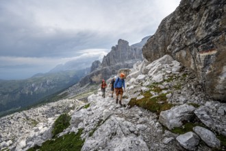 Three mountaineers on a hiking trail, rocky mountain landscape, Via Ferrata SOSAT via ferrata,