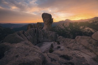Captivating sunset view over the dramatic rock formations in Pedriza, Madrid. The warm hues paint