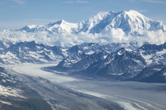 Clouds over high mountains, Mt Foraker with Kahlitna Glacier, aerial view, Alaska Range, Denali