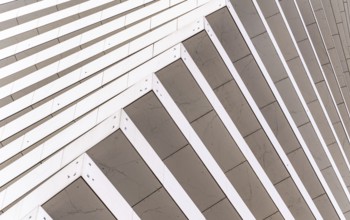 Close-up of a modern architectural facade featuring diagonal lines creating a dynamic pattern. The