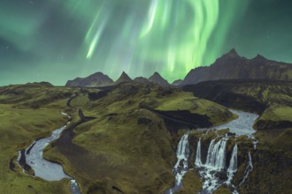 The breathtaking Northern Lights illuminate Iceland's dramatic terrain, featuring stunning