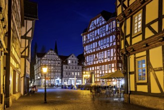 Night scene with illuminated half-timbered houses and a quiet, historic atmosphere, The old town
