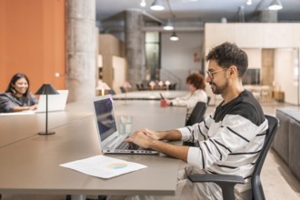 Diverse coworkers engaged in teamwork at a contemporary open space office Individuals working