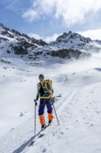 Ski tourers on the Bündner Haute Route, Albula Alps in winter, Rhaetian Alps, Graubünden, Eastern
