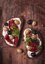 Breakfast, sandwiches, with cream cheese, olives, top view