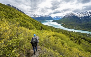 Climbers on a hiking trail, Slaughter Ridge Trail, view of snowy mountains in spring and turquoise