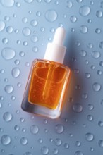 A bottle of vitamin C serum with a pipette, filled with vibrant orange liquid, is set against a