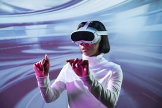 Latin woman immersed in a virtual reality experience, wearing VR glasses and interacting with a