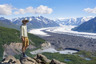 Young man enjoying the view, view of impressive mountain landscape with Matanuska glacier and