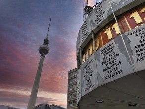 Atmospheric sunset with pink sky over Berlin World Clock and Berlin TV Tower, Alexanderplatz, Alex,