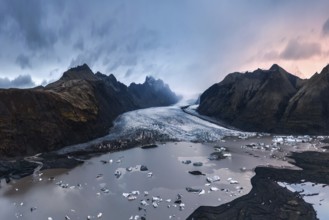 Majestic twilight view of Vatnajökull Glacier, Iceland, with scattered icebergs and dramatic