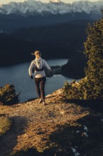 Trail running in autumn on the Jochberg on Lake Walchensee against the wonderful backdrop of the
