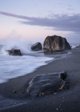 Okarito Beach, rocks, ocean, sandy beach. In the evening. long exposure. Westland Tai Poutini