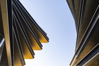 This image showcases the dynamic lines and sleek surfaces of modern architecture against a clear