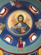 Ceiling painting with Christian Greek Orthodox motifs Jesus Christ in small church chapel in