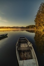 Boats in the autumnal Schmutter Weiher in the Allgäu near the municipalities of Halblech,