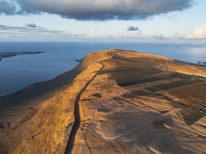Road on cliffs in evening light, steep cliffs on the coast near Mirador del Porrito, aerial view,