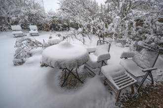 Snowy seating in a garden, Eckental, Middle Franconia, Bavaria, Germany