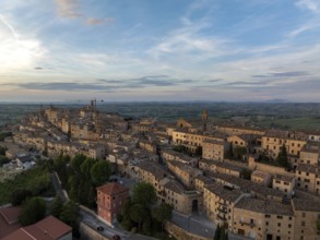 Aerial view of the historic town of Treia in Italy at sunset. The ancient architecture and warm