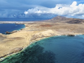 Coast with Playa Caleta del Congrio beach and blue sea, arid landscape of Los Ajaches Natural Park,