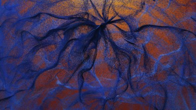 An intricate design featuring swirling particles in shades of blue and orange This abstract
