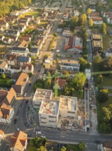 Aerial view of a city centre with a construction site in the foreground and many buildings all