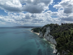 Aerial view of the stunning coastline in Sirolo, Italy. Dramatic cliffs rise from the turquoise
