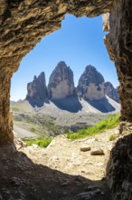 Tre cime di lavaredo peaks viewed from a Tre Cime Cave entrance in the dolomites, italy, during a
