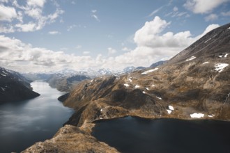 A stunning scene of interconnected mountain lakes surrounded by rugged peaks in Norway The