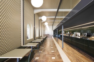 A stylish bar interior featuring geometric wall patterns, a sleek bar, and modern lighting,